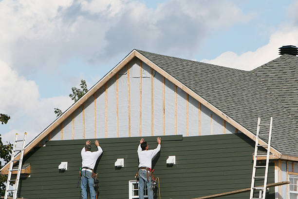 Professional Storm Damage Siding Repair technician working in Barnesville, MN